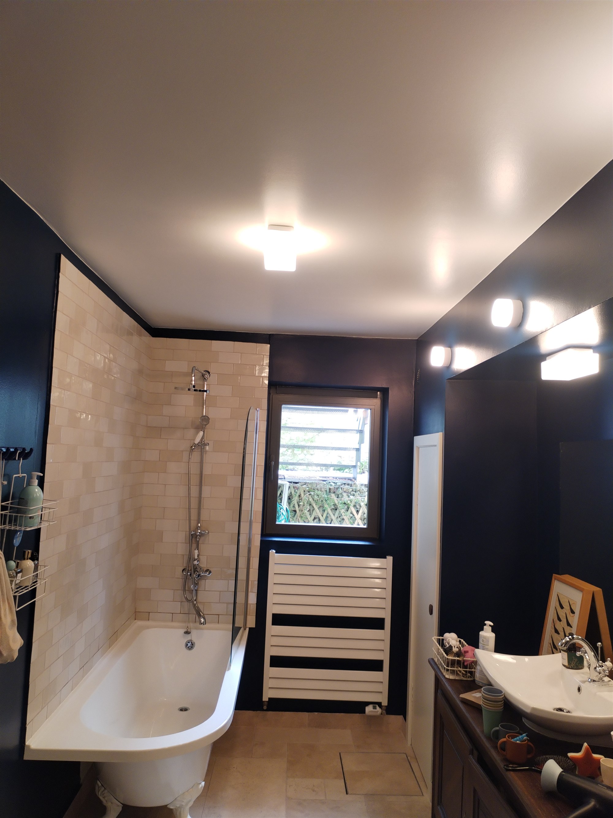 Navy blue bathroom with clawfoot bath